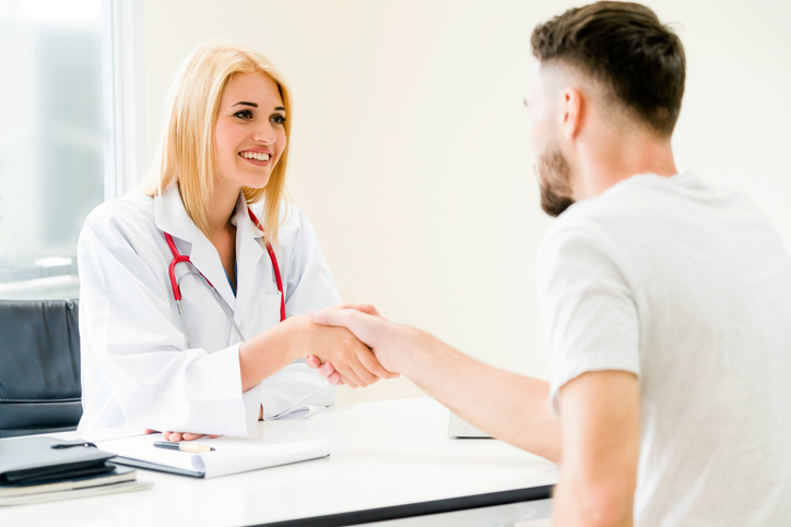 Doctor shake hand with patient in the hospital.